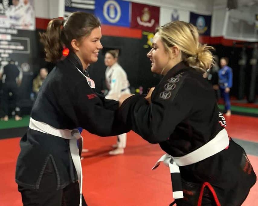 Two girls practicing Brazilian Jiu Jitsu