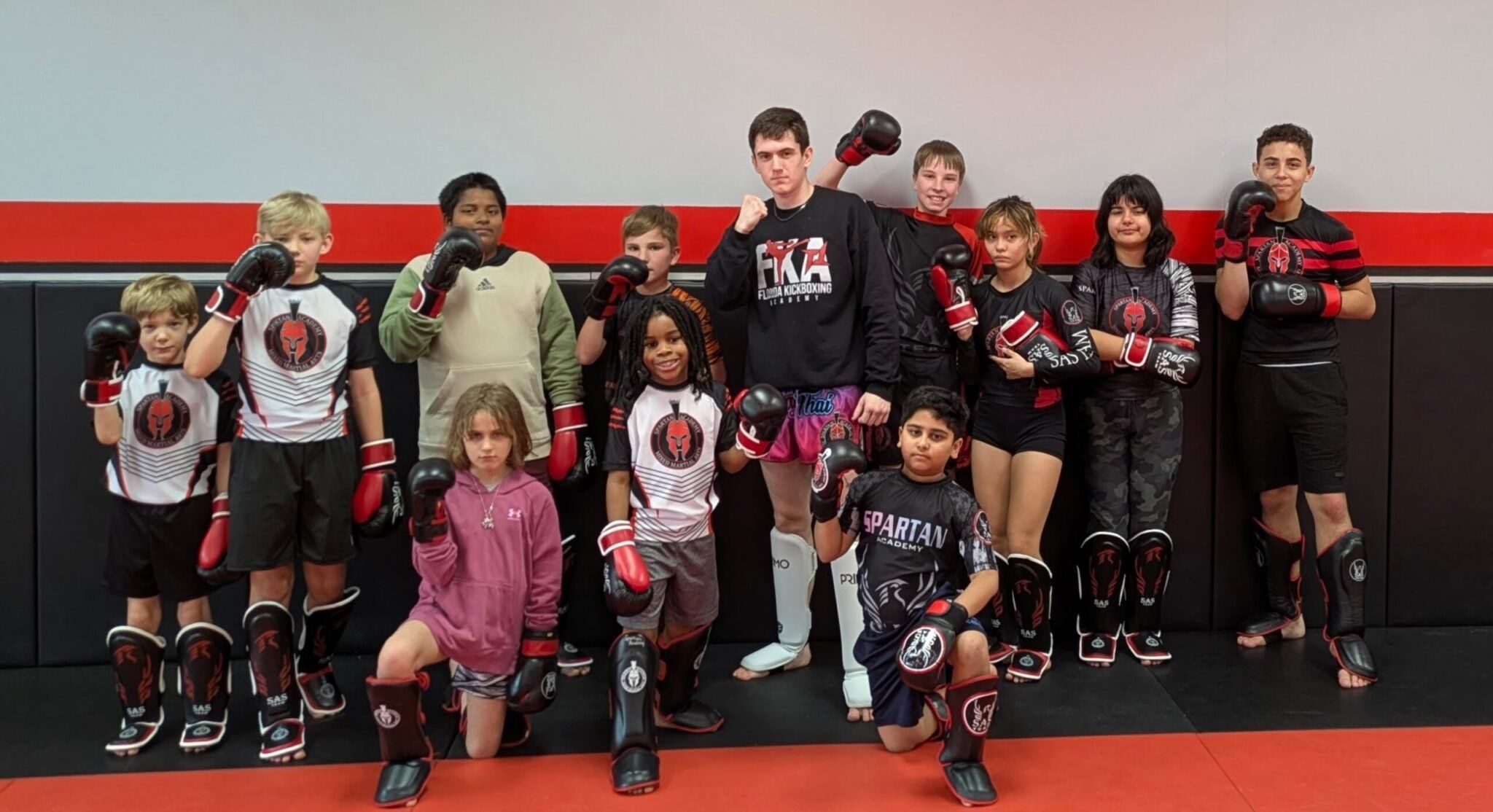 Youth MMA students developing confidence, discipline, fitness, and self-defense skills through fun, structured martial arts training at Spartan Academy.